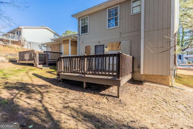 back of property featuring a deck