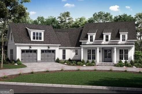 view of front of home featuring a garage, concrete driveway, board and batten siding, and a front lawn