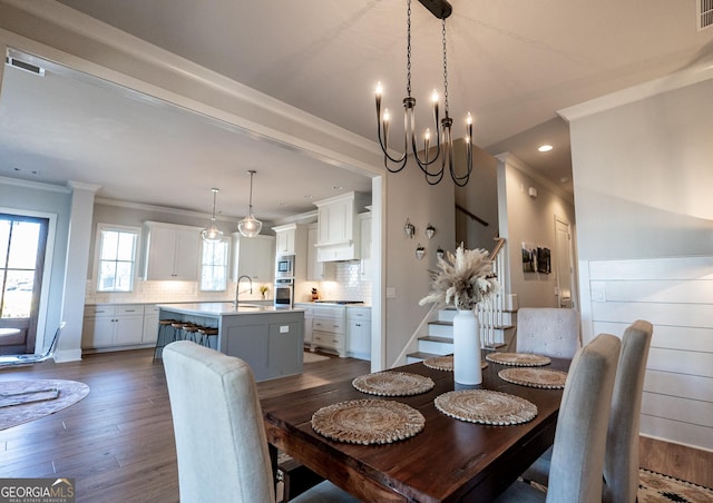 dining room featuring crown molding, visible vents, stairway, and dark wood-type flooring