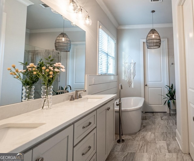 bathroom featuring marble finish floor, ornamental molding, a sink, and a soaking tub