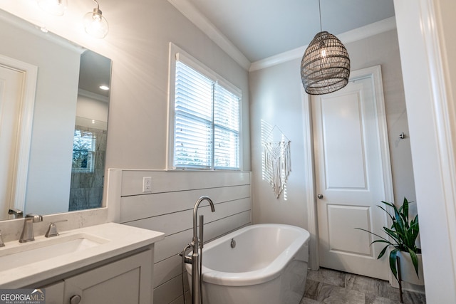 bathroom with a soaking tub, crown molding, and vanity