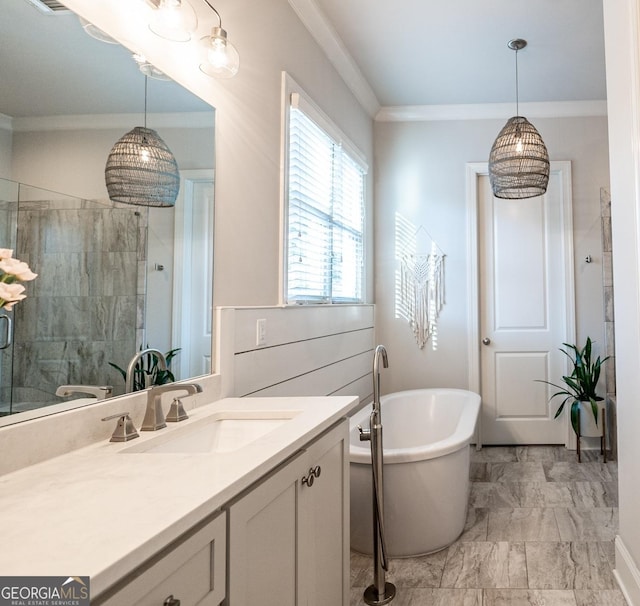 bathroom featuring marble finish floor, ornamental molding, vanity, a freestanding tub, and tiled shower