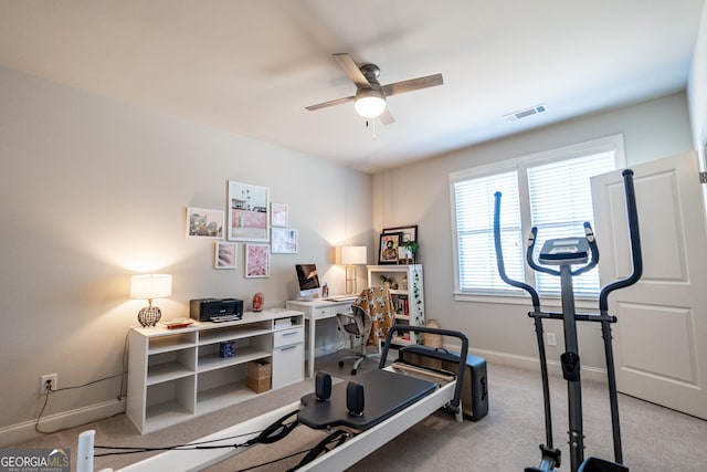 workout room featuring a ceiling fan, visible vents, light carpet, and baseboards