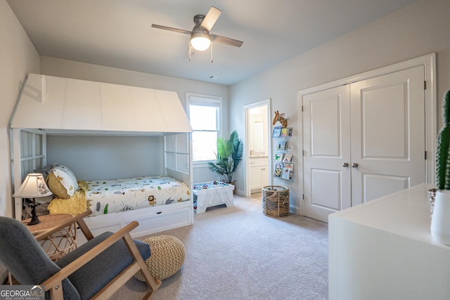 bedroom featuring light carpet, a closet, a ceiling fan, and ensuite bathroom