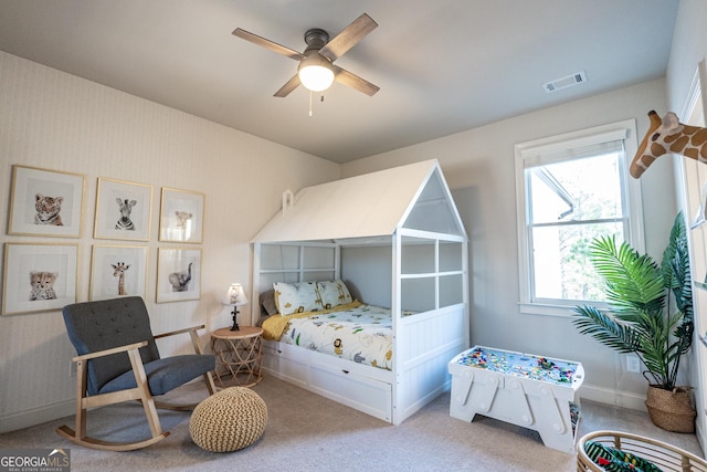 bedroom featuring carpet flooring, a ceiling fan, baseboards, visible vents, and wallpapered walls