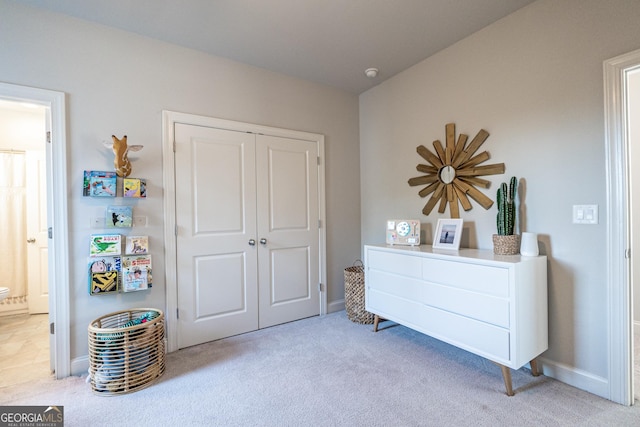 interior space featuring baseboards, a closet, and ensuite bathroom