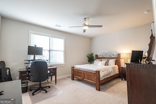 bedroom featuring light carpet, baseboards, visible vents, and a ceiling fan