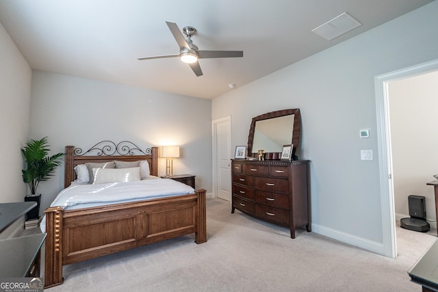 bedroom featuring a ceiling fan, visible vents, light carpet, and baseboards