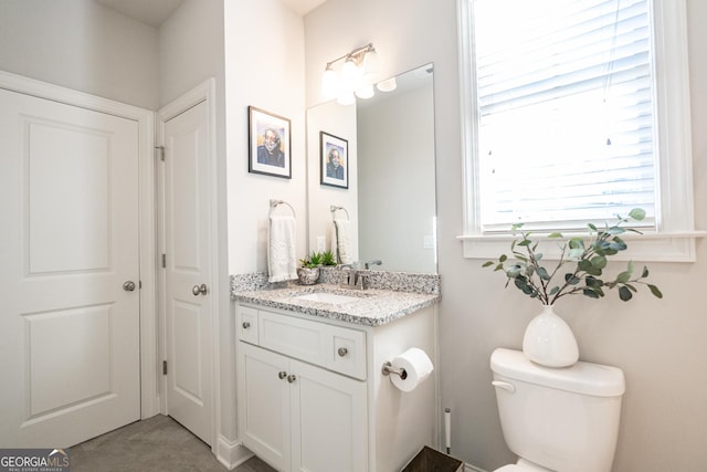 half bath with vanity and toilet