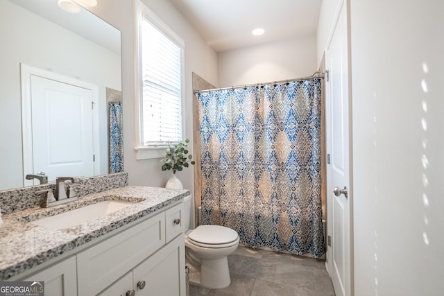 bathroom with toilet, a shower with shower curtain, and vanity