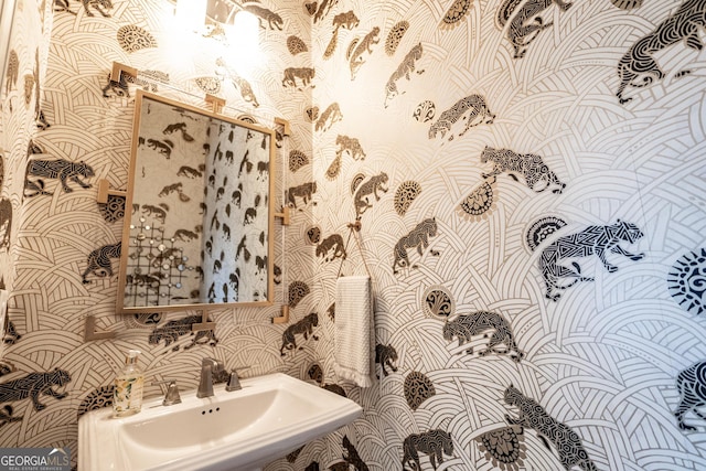 bathroom featuring wallpapered walls and a sink