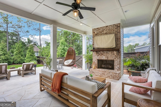 sunroom / solarium with an outdoor brick fireplace, coffered ceiling, and a ceiling fan