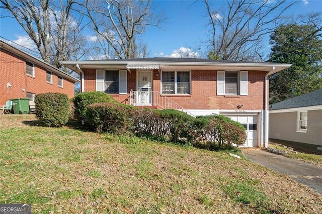 ranch-style home featuring driveway, an attached garage, a front lawn, and brick siding