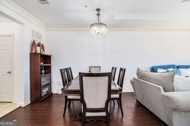 dining room with ornamental molding, baseboards, an inviting chandelier, and wood finished floors