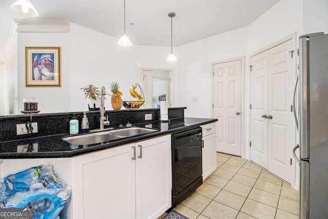 kitchen with black dishwasher, light tile patterned floors, freestanding refrigerator, white cabinetry, and a sink