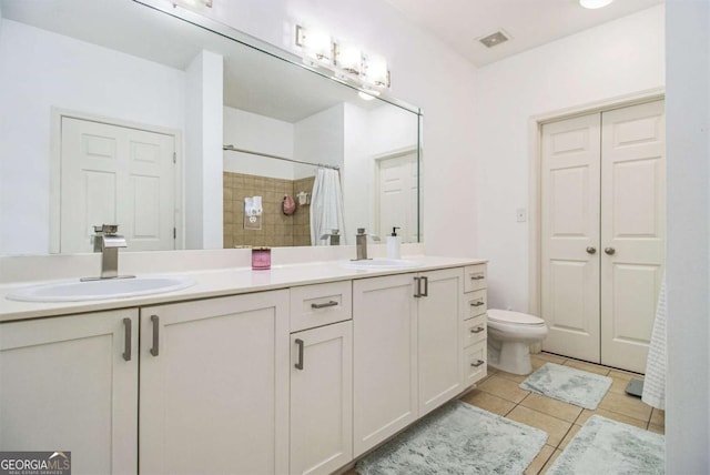 full bathroom featuring toilet, tile patterned flooring, a sink, and visible vents