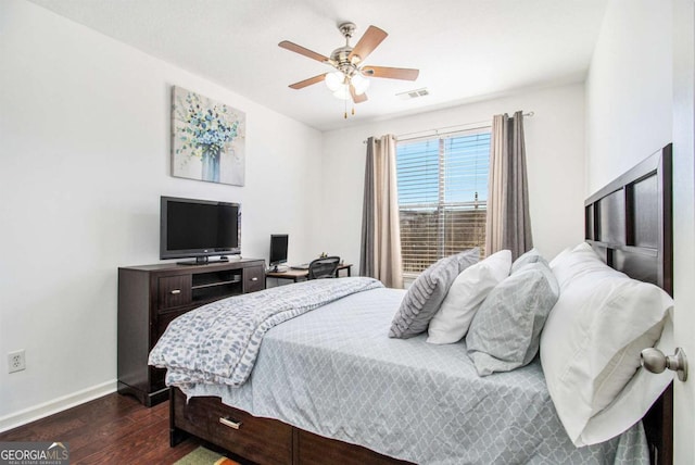 bedroom with a ceiling fan, dark wood finished floors, visible vents, and baseboards