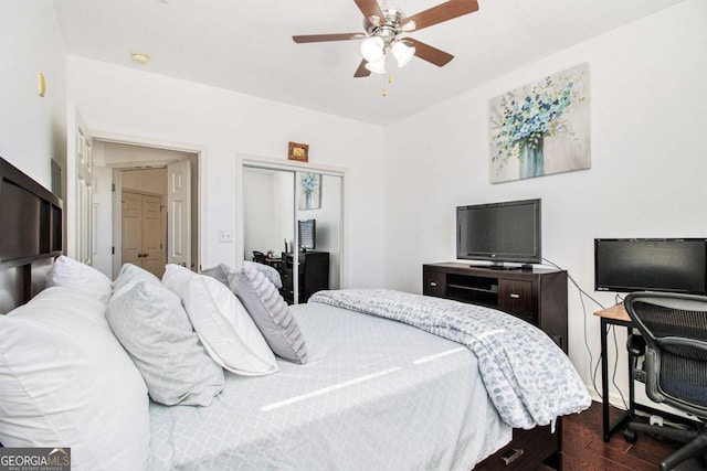 bedroom featuring ceiling fan, a closet, and wood finished floors