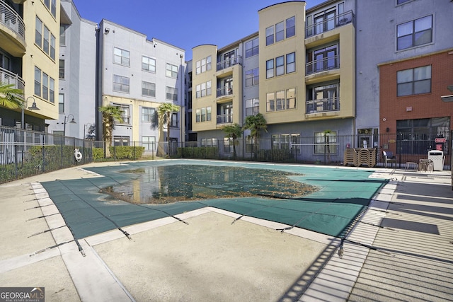 community pool featuring a patio area and fence