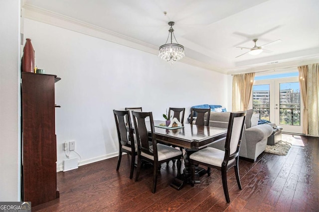 dining area featuring hardwood / wood-style flooring, ceiling fan with notable chandelier, baseboards, french doors, and ornamental molding