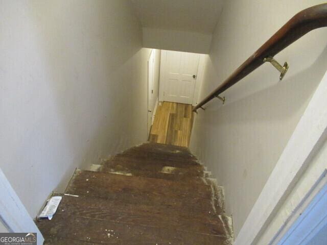 stairway featuring wood finished floors