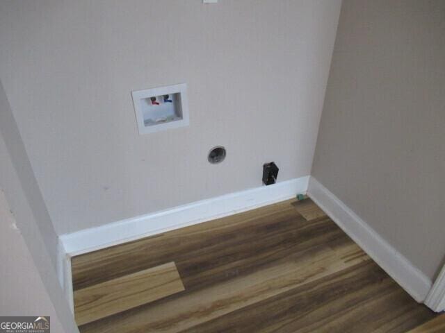 clothes washing area with washer hookup, wood finished floors, electric dryer hookup, and baseboards