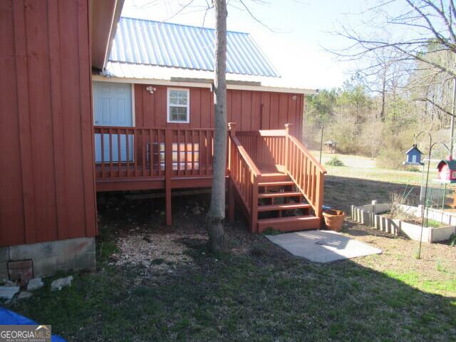 wooden terrace featuring a lawn