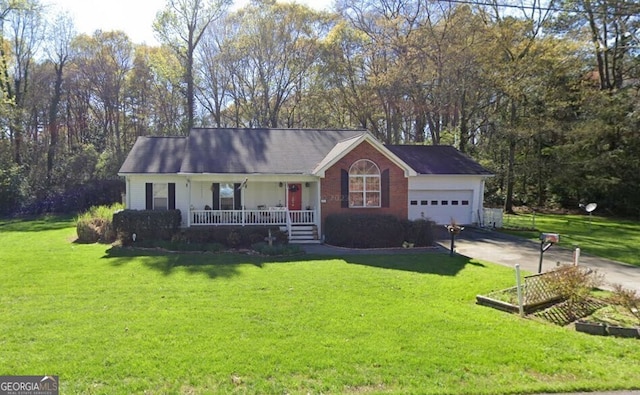 single story home with a porch, a front yard, driveway, and a garage