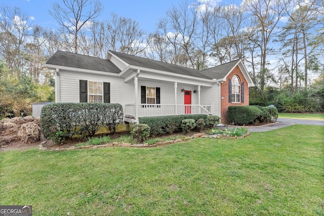 ranch-style house featuring brick siding, a porch, and a front lawn