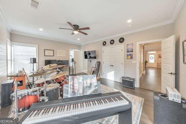 interior space featuring recessed lighting, wood finished floors, visible vents, baseboards, and ornamental molding