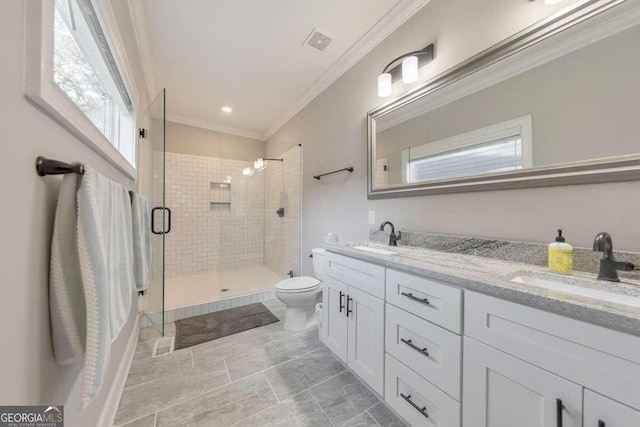 full bath featuring toilet, a stall shower, crown molding, and a sink