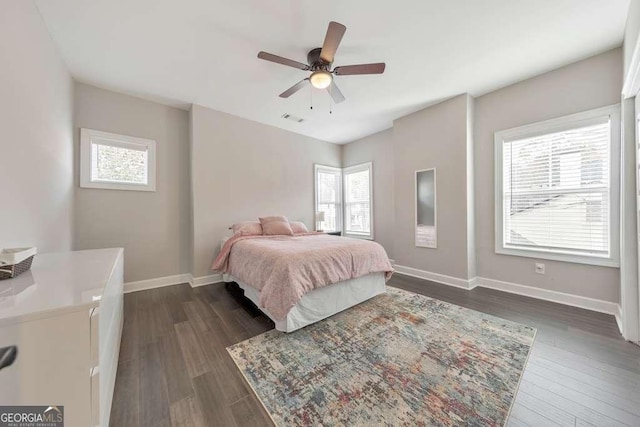 bedroom featuring baseboards, visible vents, ceiling fan, and dark wood-type flooring