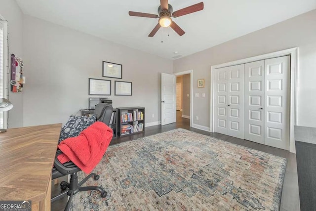 office space with a ceiling fan, baseboards, and wood finished floors