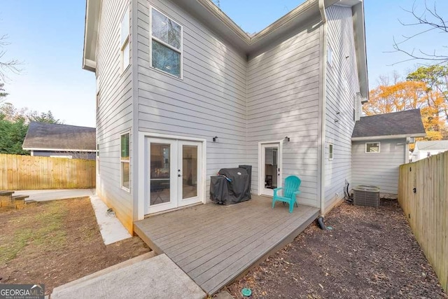 back of house with a fenced backyard, a deck, cooling unit, and french doors