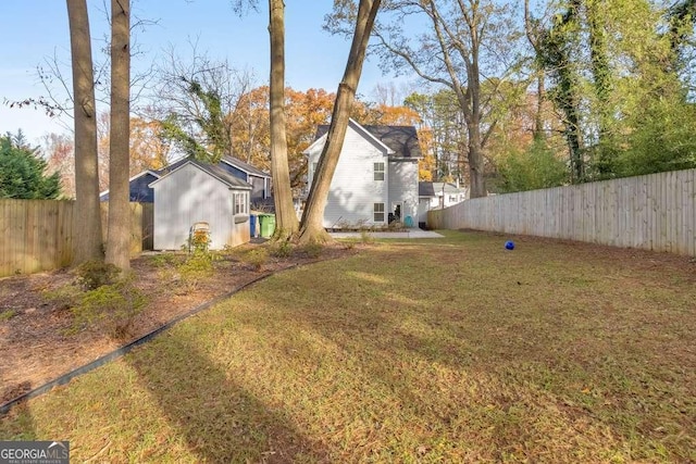 view of yard featuring an outdoor structure and a fenced backyard