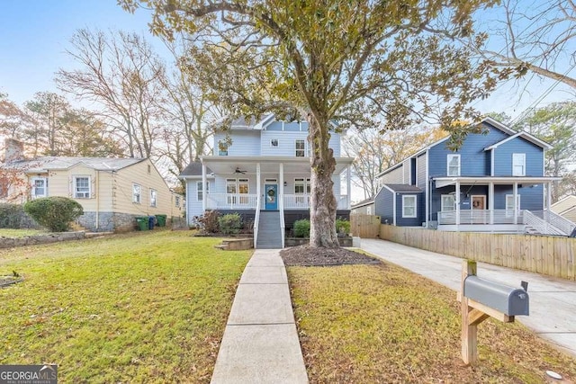 view of front of home featuring a porch, ceiling fan, and a front lawn