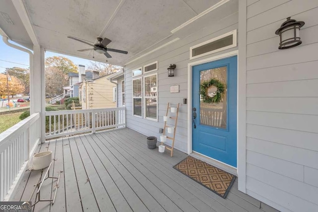 wooden deck with covered porch and ceiling fan