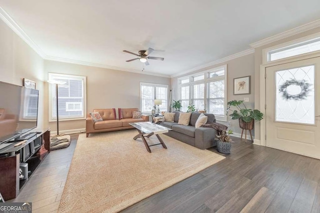 living room featuring ornamental molding, a ceiling fan, hardwood / wood-style flooring, and baseboards