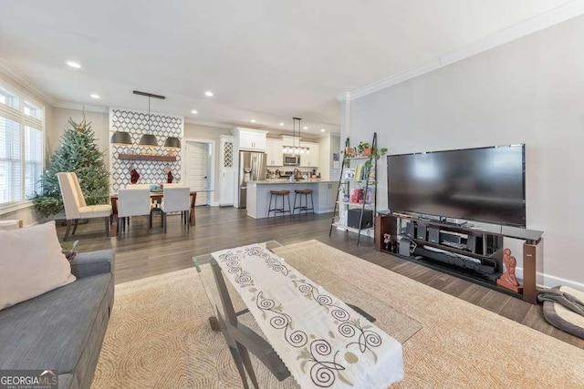 living area featuring ornamental molding, recessed lighting, dark wood-type flooring, and baseboards