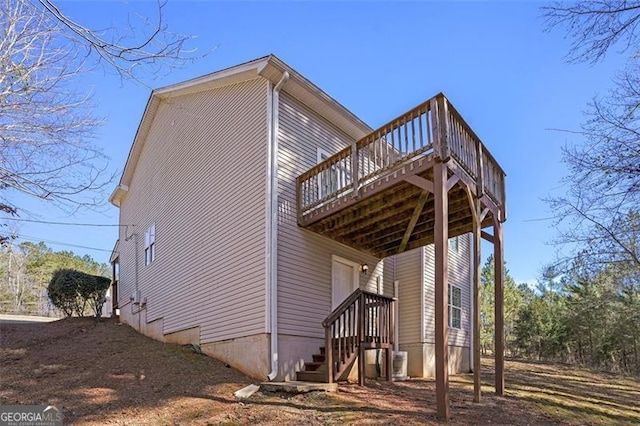 view of side of property featuring a wooden deck