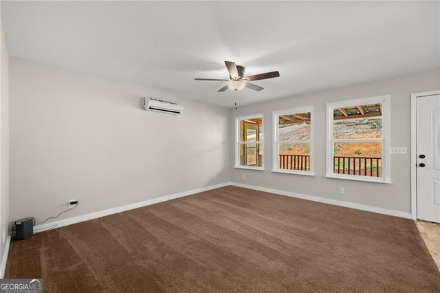 carpeted spare room with a ceiling fan, an AC wall unit, and baseboards