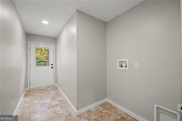 entryway with stone finish flooring and baseboards