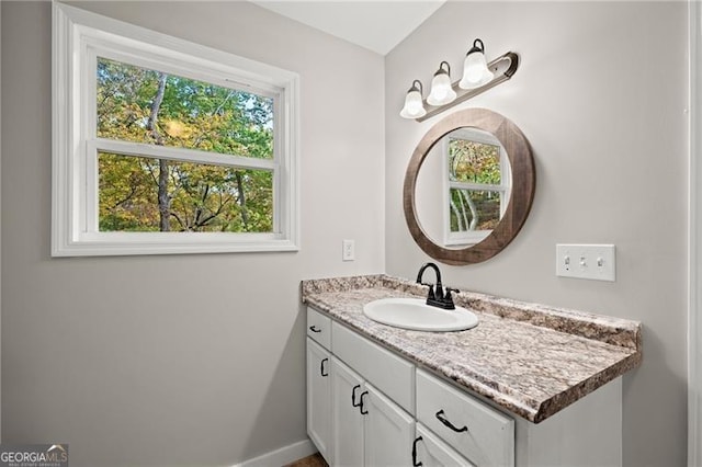 bathroom with vanity and baseboards