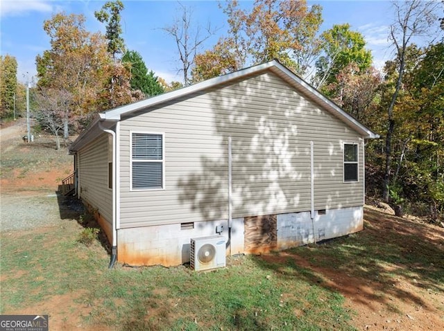 view of property exterior featuring a yard, crawl space, and ac unit