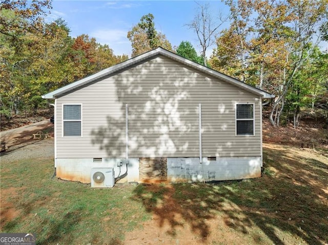 view of property exterior featuring ac unit, crawl space, and a lawn