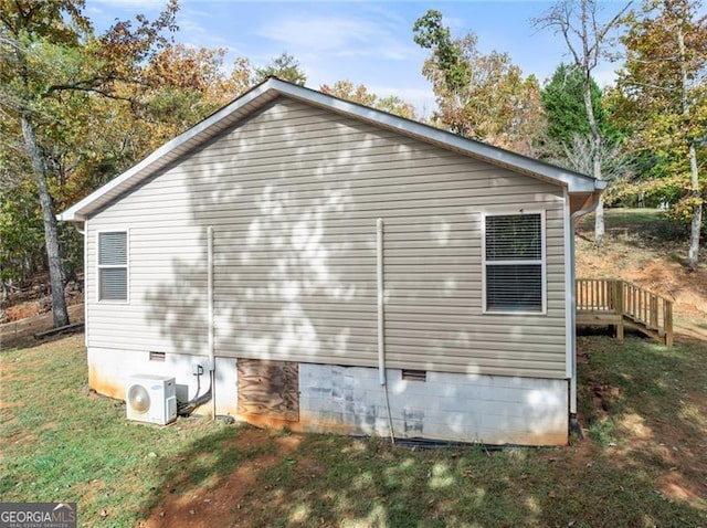 view of side of home with crawl space, ac unit, and a lawn