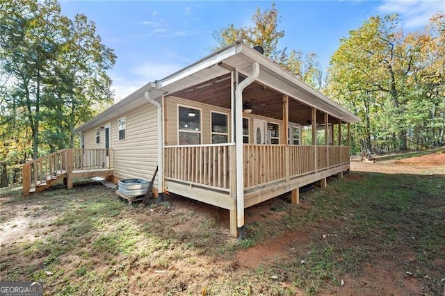 exterior space with ceiling fan