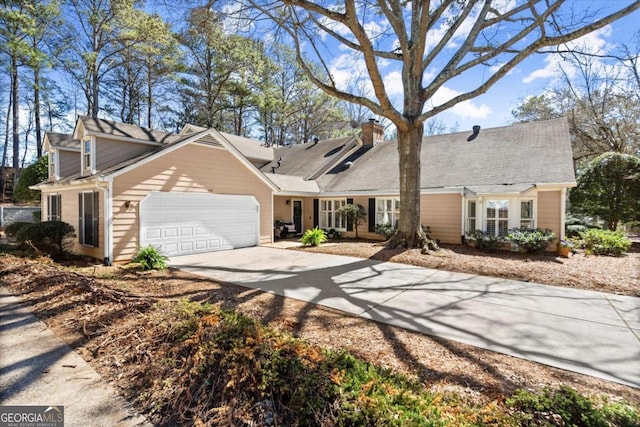 view of front of property with a garage, concrete driveway, and a chimney