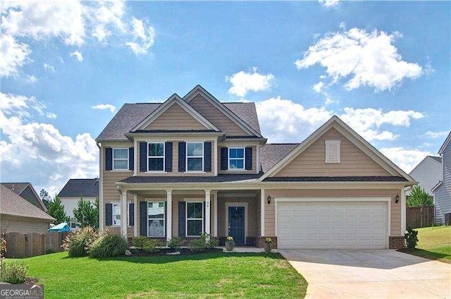 craftsman-style home featuring an attached garage, concrete driveway, a front yard, and fence