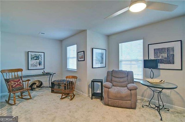 sitting room featuring visible vents, carpet floors, a ceiling fan, and baseboards